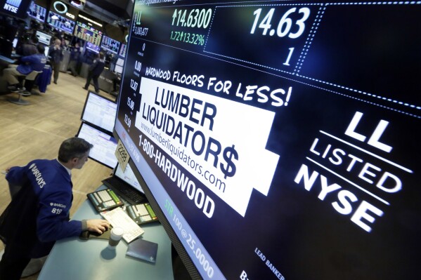 FILE - Specialist Anthony Rinaldi works on the floor of the New York Stock Exchange on Feb. 1, 2016, adjacent to the post that handles Lumber Liquidators. (AP Photo/Richard Drew, File)