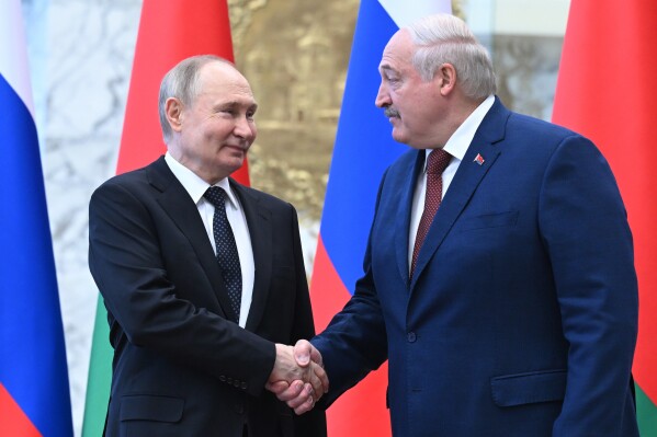 Russian President Vladimir Putin, left, and Belarusian President Alexander Lukashenko shake hands during a welcome ceremony at the Palace of Independence in Minsk, Belarus, Friday, May 24, 2024. (Dmitriy Azarov, Sputnik, Kremlin Pool Photo via AP)