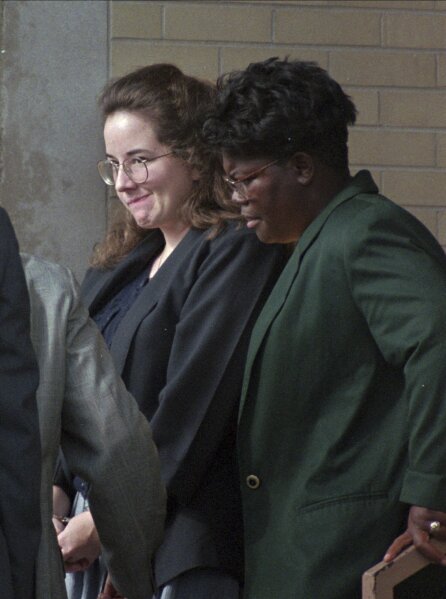 Convicted murderer Susan Smith is escorted from the Union County Courthouse on July 28, 1995 by corrections officer Felicia Mungo after being sentenced to life in prison for the drowning deaths of her two boys last October. (AP Photo/Lou Krasky)