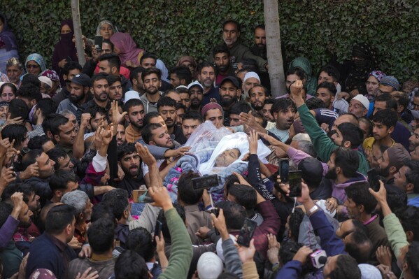 Villagers carry the body of Kashmiri doctor Shahnawaz who was among those killed when gunmen fired at people working on a strategic tunnel project in Indian-controlled Kashmir, during his funeral at Nadigam village, southwest of Srinagar, Monday, Oct. 21, 2024. (AP Photo/Mukhtar Khan)