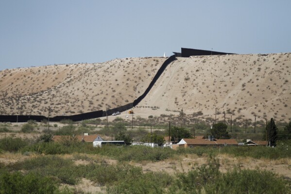 Border Patrol vehicles survey a steel fence at the Southwest border with Mexico at Sunland Park, N.M., Thursday, Aug. 22, 2024. (AP Photo/Morgan Lee, File)