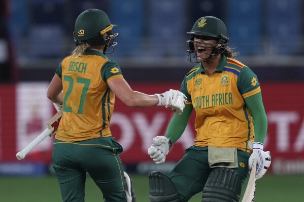 South Africa's Anneke Bosch and Chloé Tryon celebrate after wining against Australia during the ICC Women's T20 World Cup 2024 semi-final match at Dubai International Cricket Stadium, United Arab Emirates, Thursday, Oct. 17, 2024. (AP Photo/Altaf Qadri)