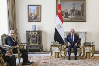 In this photo provided by Egypt's presidency media office, Egyptian President Abdel-Fattah el-Sissi, right, meets with Iranian Foreign Minister Abbas Araghchi, at the Presidential Palace in Cairo, Egypt, Thursday, Oct.17, 2024. (Egyptian Presidency Media Office via AP)