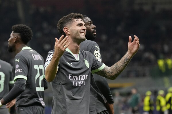 AC Milan's Christian Pulisic reacts after scoring the opening goal of his team during the Champions League opening phase soccer match between AC Milan and Club Brugge at the San Siro stadium in Milan, Italy, Tuesday, Oct. 22, 2024. (AP Photo/Antonio Calani)