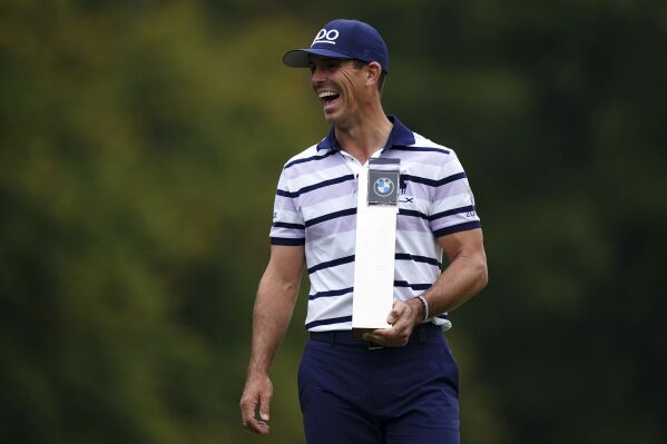 Billy Horschel of the U.S. displays the trophy following day four of the PGA Championship at Wentworth Golf Club in Virginia Water, England, Sunday Sept. 22, 2024. (Zac Goodwin/PA via AP)