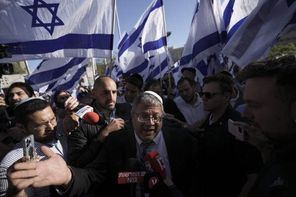 FILE - Israeli lawmaker Itamar Ben-Gvir, center, speaks to the media surrounded by right wing activists as they gather for a march in Jerusalem, April 20, 2022. Ben-Gvir visited Jerusalem’s most sensitive holy site Thursday, July 18, 2024, a move that could threaten the delicate Gaza cease-fire talks. (AP Photo/Ariel Schalit, File)