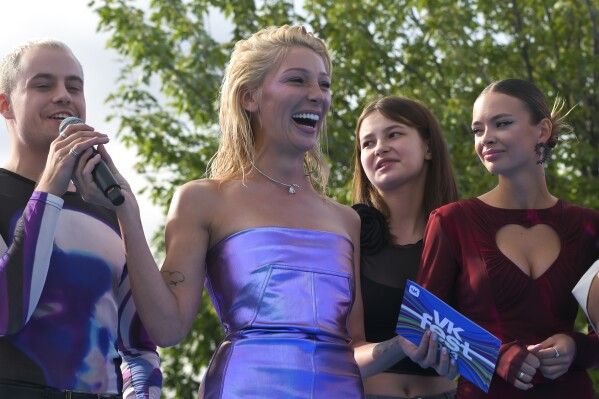 FILE TV presenter and actress Anastasia Ivleeva, center, performs during the VK Festival in Moscow, Russia, Saturday, July 15, 2023. A court in Moscow on Wednesday turned back a class-action lawsuit against a Russian TV presenter that sought $11 million in moral damages for her hosting a party where guests were encouraged to show up wearing next to nothing. The suit against Anastasia Ivleeva was one element of a scandal that erupted after her bash at a Moscow nightclub and sent a well-known rapper who attended wearing only a sock around his genitals and two on his feet to jail. (AP Photo, File)