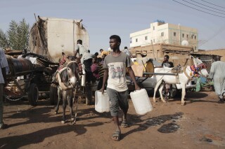 FILE - People gather to collect water in Khartoum, Sudan, on May 28, 2023, during a weeklong truce, brokered by the U.S. and the Saudis. A week of indirect talks involving Sudan's warring parties ended in Geneva on Friday, July 19, 2024, the U.N. secretary-general's personal envoy said. He described the discussions as an “encouraging initial step” in a complex process.(AP Photo/Marwan Ali)