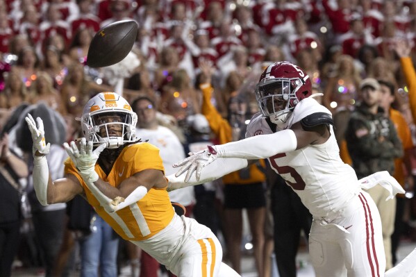 CORRECTS PLAYERS NAME TO CHRIS BRAZZELL II FROM CHAS NIMROD - Tennessee wide receiver Chris Brazzell II (17) catches a pass for a touchdown as he's defended by Alabama defensive back King Mack (5) during the second half of an NCAA college football game Saturday, Oct. 19, 2024, in Knoxville, Tenn. (AP Photo/Wade Payne)