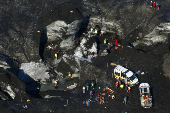 Rescue teams work at the scene after an ice cave partially collapsed, at the Breidamerkurjokull glacier, in southeastern Iceland, Monday, Aug, 26, 2024. (STOD2/ Vilhelm Gunnarsson via AP)