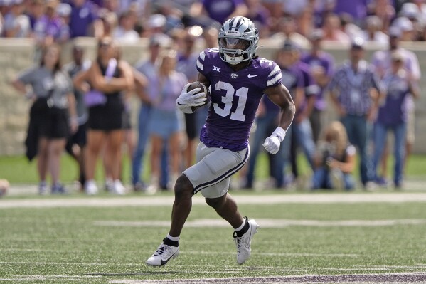 FILE -Kansas State running back DJ Giddens runs the ball during the second half of an NCAA college football game against Oklahoma State, Sept. 28, 2024, in Manhattan, Kan. (AP Photo/Charlie Riedel, File)