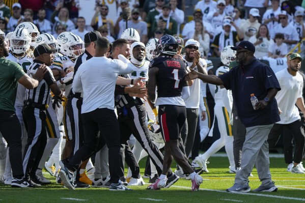 Houston Texans wide receiver Stefon Diggs (1) gets into a scuffle before an NFL football game against the Green Bay Packers, Sunday, Oct. 20, 2024, in Green Bay, Wis. (AP Photo/Morry Gash)