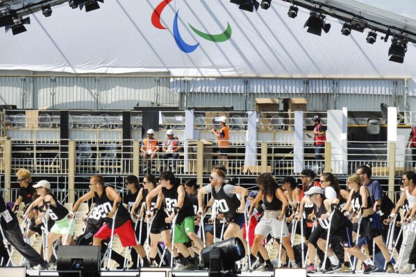 A group of dancers use crutches during the rehearsal of the Paralympic Games opening ceremony in La Concorde square, Monday, Aug. 26, 2024 in Paris, France. (AP Photo/Tom Nouvian)