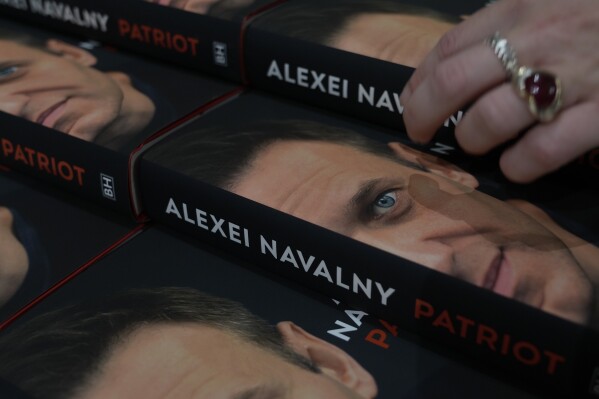 Copies of the late Russian opposition leader Alexei Navalny's memoir entitled 'Patriot' are put display on the first day of sale in a bookshop in London, Tuesday, Oct. 22, 2024. (AP Photo/Alastair Grant)