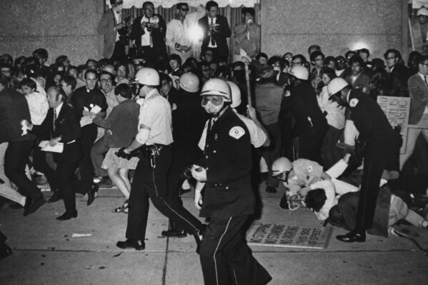 FILE - Chicago Police attempt to disperse demonstrators outside the Conrad Hilton, Democratic National Convention headquarters, Aug. 29, 1968, in Chicago. (AP Photo/Michael Boyer, File)