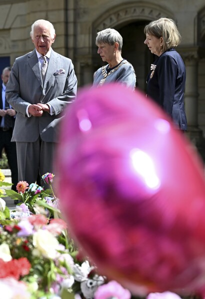 Britain's King Charles III meets with members of the local community outside Southport Town Hall, in Southport, England, Tuesday Aug. 20, 2024, following the July 29 attack at a children's dance party. (Paul Ellis/Pool via AP)