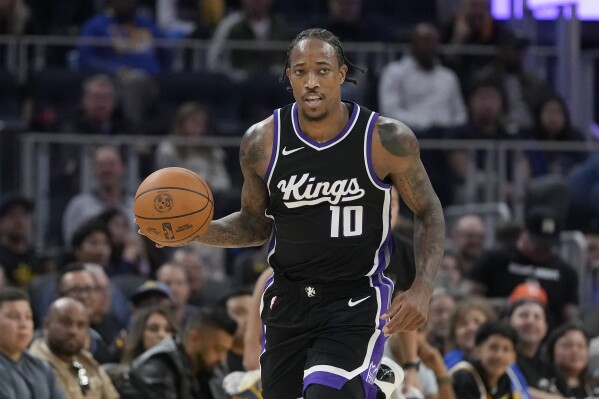 Sacramento Kings forward DeMar DeRozan (10) brings the ball up the court against the Golden State Warriors during the first half of an NBA preseason basketball game in San Francisco, Friday, Oct. 11, 2024. (AP Photo/Jeff Chiu)