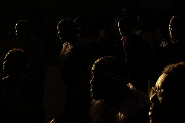 Pilgrims arrive inside San Felipe Church to honor the Black Christ in Portobelo, Panama, early Monday, Oct. 21, 2024, during a festival celebrating the iconic statue that was found on the shore in 1658. (AP Photo/Matias Delacroix)