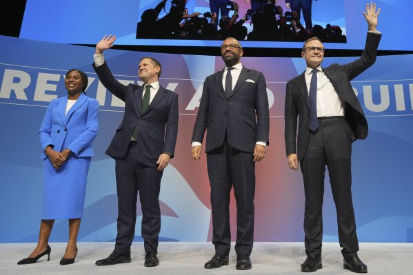 Conservative leadership candidates Kemi Badenoch, from left, Robert Jenrick, James Cleverly and om Tugendhat stand on the podium during the Conservative Party Conference at the International Convention Centre in Birmingham, England, Wednesday, Oct. 2, 2024.(AP Photo/Kin Cheung)