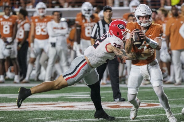 Texas quarterback Quinn Ewers (3) is sacked for a loss by Georgia linebacker Chaz Chambliss (32) during the second half of an NCAA college football game in Austin, Texas, Saturday, Oct. 19, 2024. (AP Photo/Rodolfo Gonzalez)