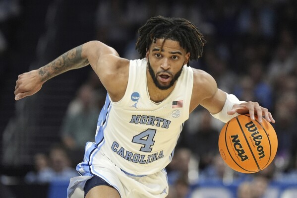 FILE - North Carolina guard RJ Davis (4) brings the ball down court during the first half of a second-round college basketball game against Michigan State in the NCAA Tournament, Saturday, March 23, 2024, in Charlotte, N.C. (AP Photo/Chris Carlson, File)