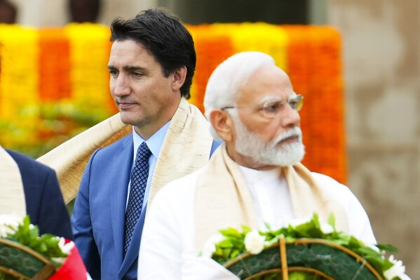 FILE - Canada's Prime Minister Justin Trudeau, left, walks past India's Prime Minister Narendra Modi as they take part in a wreath-laying ceremony at Raj Ghat, Mahatma Gandhi's cremation site, during the G20 Summit in New Delhi, Sept. 10, 2023. (Sean Kilpatrick/The Canadian Press via AP, File)