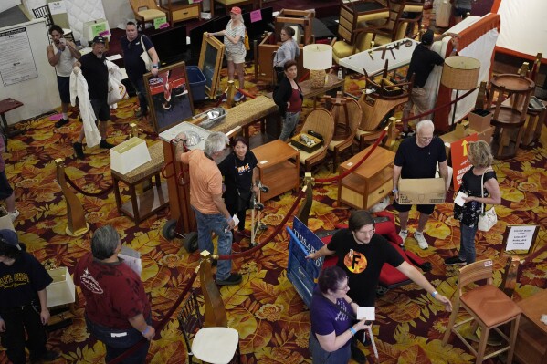 People line up to pay for items during a sale at the shuttered Tropicana hotel-casino Saturday, May 25, 2024, in Las Vegas. (AP Photo/John Locher)