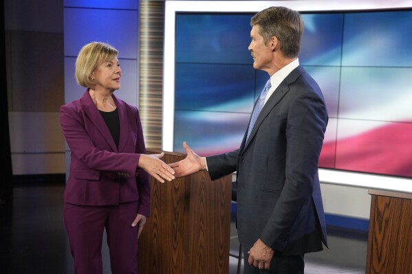 Wisconsin Senate candidates Republican Eric Hovde and Democratic U.S. Sen. Tammy Baldwin shake hands before a televised debate Friday, Oct. 18, 2024, in Madison, Wis. (AP Photo/Morry Gash)