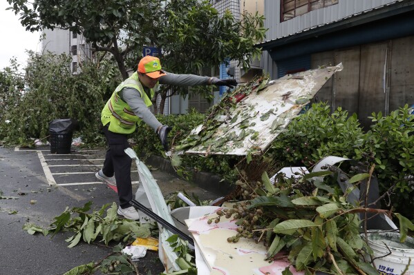 A sanitation worker of Kaohsiung city government clears debris in the aftermath of Typhoon Krathon in Kaohsiung, southern Taiwan, Friday, Oct. 4, 2024. (AP Photo/Chiang Ying-ying)