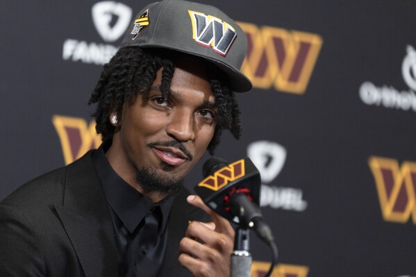 Washington Commanders' first round draft pick Jayden Daniels speaks to reporters during an NFL football news conference in Ashburn, Va., Friday, April 26, 2024. (AP Photo/Manuel Balce Ceneta)