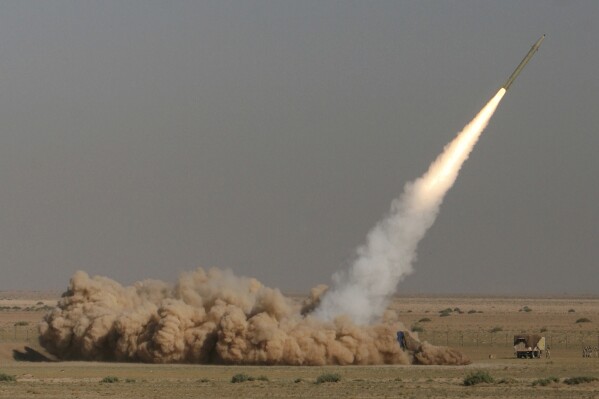 FILE - In this photo released by the Iranian semi-official Fars News Agency, Revolutionary Guard's Fateh missile is launched in a drill near the city of Qom, 80 miles (130 kilometers) south of the capital Tehran, Iran, Sept. 27, 2009. (Ali Shaigan/Fars News Agency via AP File)