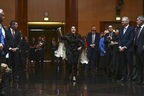 Australian Senator Lidia Thorpe, center, disrupts proceedings as Britain's King Charles III and Queen Camilla attend a Parliamentary reception hosted by Australian Prime Minister Anthony Albanese and partner Jodie Jaydon at Parliament House in Canberra, Australia, Monday, Oct. 21, 2024. (Lukas Coch/Pool Photo via AP)