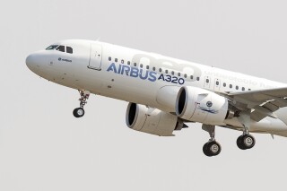 FILE - The new Airbus A320neo takes off for its first test flight at Toulouse-Blagnac airport, southwestern France, Sept. 25, 2014. Some Airbus passenger jets will need to have their engines removed and inspected in the coming months because engine maker Pratt & Whitney is finding a problem with metal powder used in some parts. Pratt and Whitney parent RTX Corp. reported the issue on Tuesday, July 25, 2023. The engine involved is most often used to power the Airbus A320neo. (AP Photo/Frederic Lancelot, File)