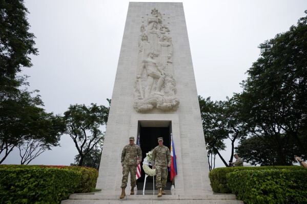 U.S. Maj. Gen. Marcus Evans, right, commanding general of the U.S. Army's 25th Infantry Division and Sgt. Major Shaun Curry walk after a wreath laying rite to honor American soldiers died during World War II at the Manila American Cemetery and Memorial in Taguig, Philippines Monday, Oct. 21, 2024. (AP Photo/Aaron Favila)