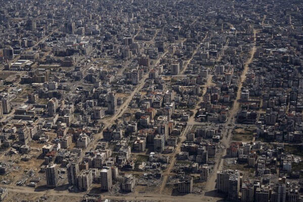 FILE - Destroyed buildings are seen through the window of an airplane from the U.S. Air Force overflying the Gaza Strip, on March 14, 2024. (AP Photo/Leo Correa, File)