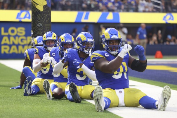 Los Angeles Rams players celebrate a fumble returned for a defensive touchdown by safety Kamren Curl (3) during the second half of an NFL football game against the Las Vegas Raiders, Sunday, Oct. 20, 2024, in Inglewood, Calif. (AP Photo/Ryan Sun)