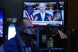 FILE - President Jose Biden appears on a screen as trader Mark Puetzer works on the floor of the New York Stock Exchange, Nov. 29, 2021. From Mexico to France to India, investors have been getting bitter reminders recently that elections have consequences for financial markets. More opportunities for such volatility are on the way, with elections set for the United Kingdom in July and the United States in November, among other major nations. (AP Photo/Richard Drew, File)