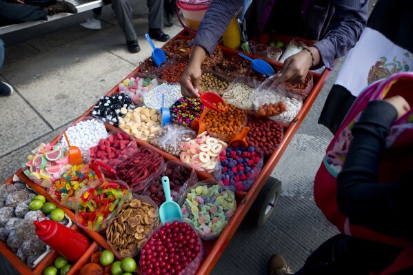 ARCHIVO - Un comerciante callejero vende dulces en Ciudad de México el 5 de julio de 2016. (AP Foto/Eduardo Verdugo, Archivo)