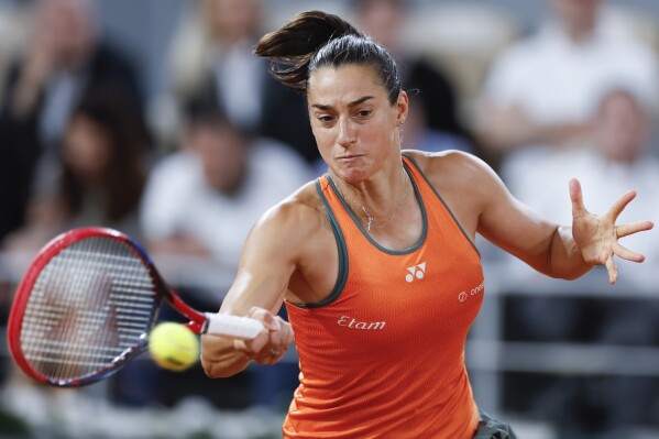 France's Caroline Garcia plays a shot against Sofia Kenin of the U.S. during their second round match of the French Open tennis tournament at the Roland Garros stadium in Paris, Wednesday, May 29, 2024. (AP Photo/Jean-Francois Badias)