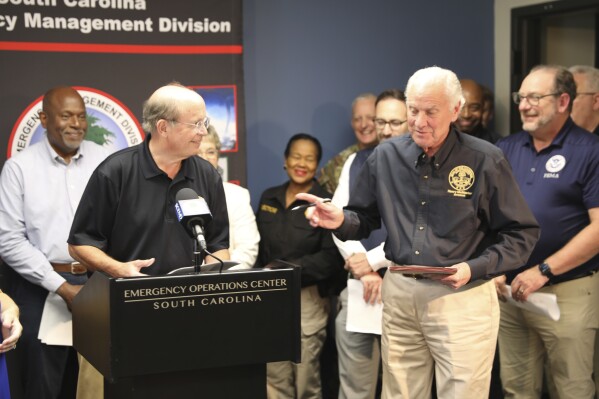 South Carolina Gov. Henry McMaster, right, asks a question of South Carolina Emergency Management Director Kim Stenson, left, during a news conference Thursday, Oct. 3, 2024, in West Columbia, S.C. (AP Photo/Jeffrey Collins)