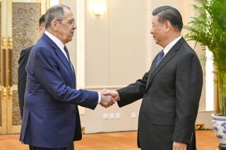 In this photo released by Xinhua News Agency, Russian Foreign Minister Sergey Lavrov, left, and Chinese President Xi Jinping meets at the Great Hall of the People in Beijing on April 9, 2024. China has surged sales to Russia of machine tools, microelectronics and other technology that Moscow in turn is using to produce missiles, tanks, aircraft and other weaponry. That's according to two senior Biden administration officials who discussed the sensitive findings on the condition of anonymity. Russia's microelectronics came from China, which Russia has used missiles, tanks and aircraft. (Li Xueren/Xinhua via AP)