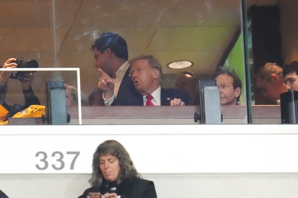 Republican presidential nominee former President Donald Trump watches the first half of an NFL football game between the Pittsburgh Steelers and the New York Jets in Pittsburgh, Sunday, Oct. 20, 2024. (AP Photo/Gene J. Puskar)