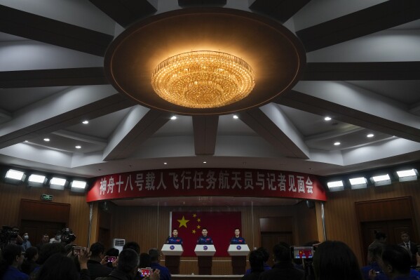 Chinese astronauts for the upcoming Shenzhou-18 mission Ye Guangfu, center, Li Guangsu, left, and Li Cong attend a meeting with the press at the Jiuquan Satellite Launch Center in northwest China, Wednesday, April 24, 2024. (AP Photo/Andy Wong)