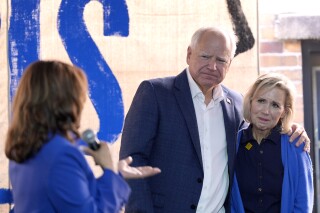 Democratic presidential nominee Vice President Kamala Harris, from left, addresses Democratic vice presidential nominee Minnesota Gov. Tim Walz and his wife Gwen Walz at a campaign event, Sunday, Aug. 18, 2024, in Rochester, Pa. (AP Photo/Julia Nikhinson)