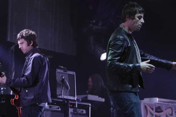 FILE - Noel, left, and Liam Gallagher, of Oasis, perform during the start of their Canadian tour in Vancouver, B.C., on Aug. 27, 2008. (Darryl Dyck/The Canadian Press via AP, File)