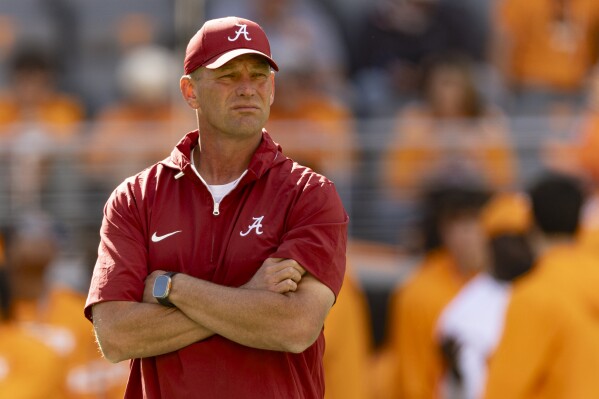 Alabama head coach Kalen DeBoer watches as his team warms up before an NCAA college football game against Tennessee, Saturday, Oct. 19, 2024, in Knoxville, Tenn. (AP Photo/Wade Payne)