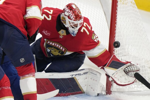 Florida Panthers goaltender Sergei Bobrovsky (72) deflects a shot during the first period of an NHL hockey game against the Vancouver Canucks, Thursday, Oct. 17, 2024, in Sunrise, Fla. (AP Photo/Wilfredo Lee)