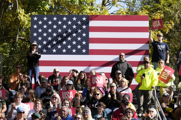 Attendees listen as Democratic presidential nominee Vice President Kamala Harris speaks during a campaign event at Riverside Park in Grand Rapids, Mich., Friday, Oct. 18, 2024. (AP Photo/Jacquelyn Martin)