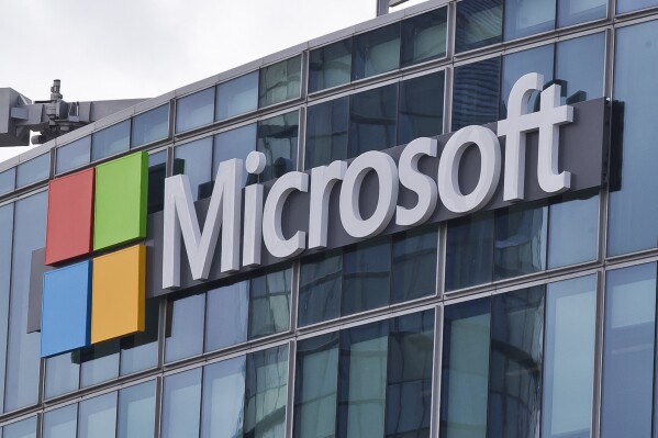 FILE - This April 12, 2016, file photo shows the Microsoft logo in Issy-les-Moulineaux, outside Paris, France. Russia, China and Iran are expanding their partnerships with cyber criminals to conduct cyberespionage and cyberattacks against the U.S. and other nations, according to a new report from Microsoft. Analysts at the tech giant say partnerships between authoritarian governments and criminal networks have benefits for both sides, increasing the volume and effectiveness of the cyber operations while giving criminals new avenues to profit and protection from prosecution. (AP Photo/Michel Euler, File)