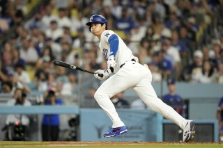 Los Angeles Dodgers' Shohei Ohtani heads to first as he lines out during the seventh inning of a baseball game against the Milwaukee Brewers Friday, July 5, 2024, in Los Angeles. (AP Photo/Mark J. Terrill)